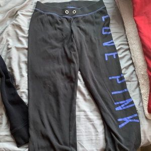 Pink sweatpants, black with blue writing